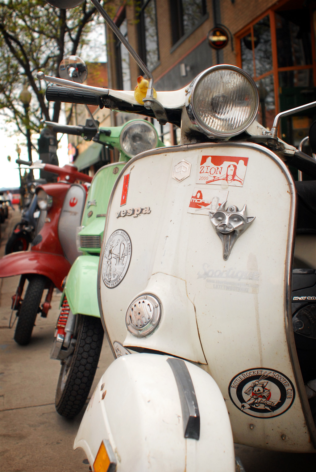 Photograph of Vespas parked off of the street downtown Denver Colorado